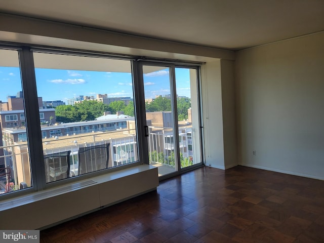 unfurnished room with dark parquet floors