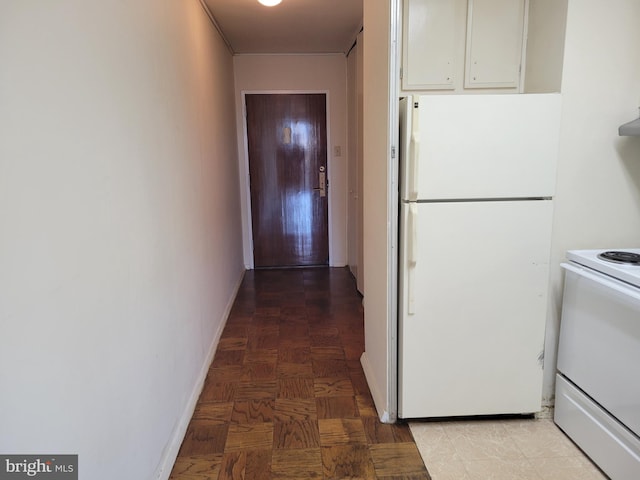 kitchen with white cabinets and white appliances