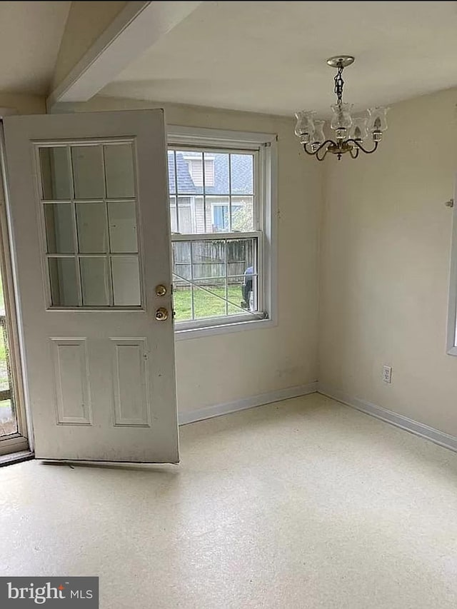 foyer entrance featuring a chandelier and beamed ceiling