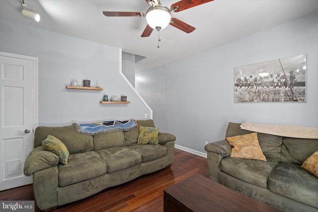 living room featuring ceiling fan and dark hardwood / wood-style flooring