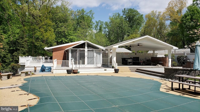 rear view of house featuring a pool side deck, ceiling fan, and a patio