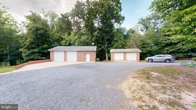 view of front facade with an outbuilding and a garage