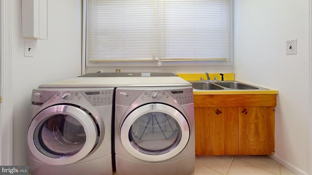 clothes washing area featuring cabinets, washer and clothes dryer, sink, and light tile patterned floors