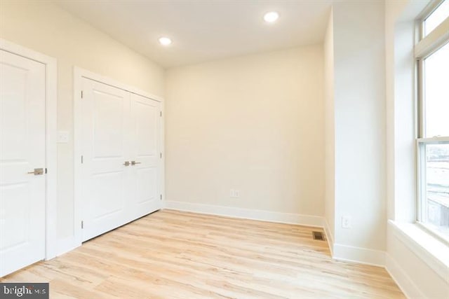 unfurnished bedroom with light wood-type flooring