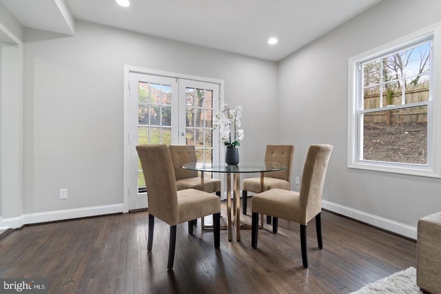 dining room with plenty of natural light, dark hardwood / wood-style floors, and french doors