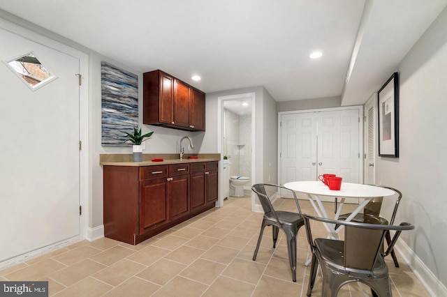 kitchen featuring light tile patterned floors and sink