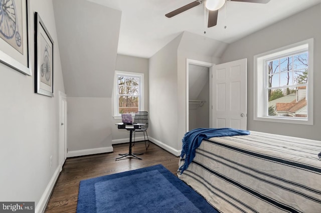 bedroom with dark hardwood / wood-style flooring, multiple windows, lofted ceiling, and ceiling fan