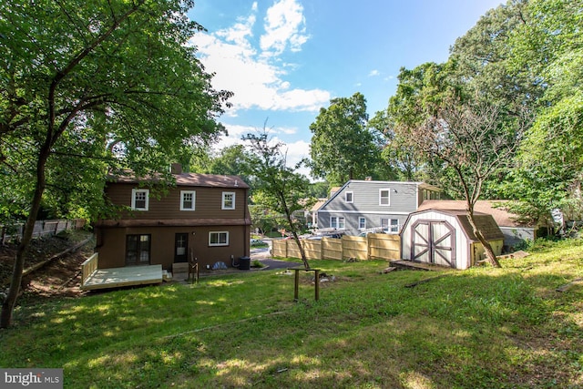 view of yard featuring a storage shed and a wooden deck