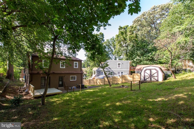 view of yard featuring a shed and a deck