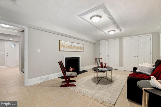 sitting room featuring light tile patterned floors and a textured ceiling