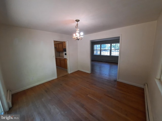 interior space with dark hardwood / wood-style flooring, baseboard heating, and an inviting chandelier