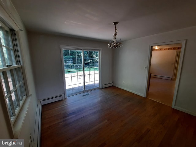 unfurnished dining area featuring dark hardwood / wood-style flooring, a chandelier, and a baseboard heating unit