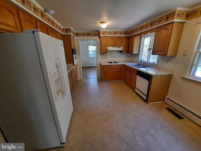 kitchen featuring plenty of natural light, white appliances, sink, and a baseboard heating unit