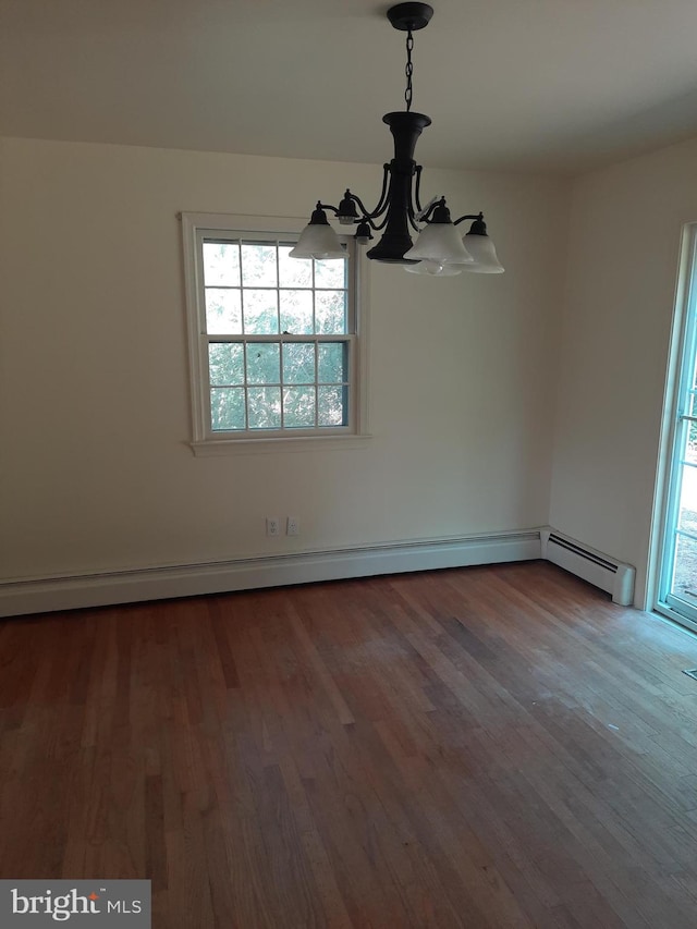 unfurnished dining area featuring wood-type flooring and an inviting chandelier