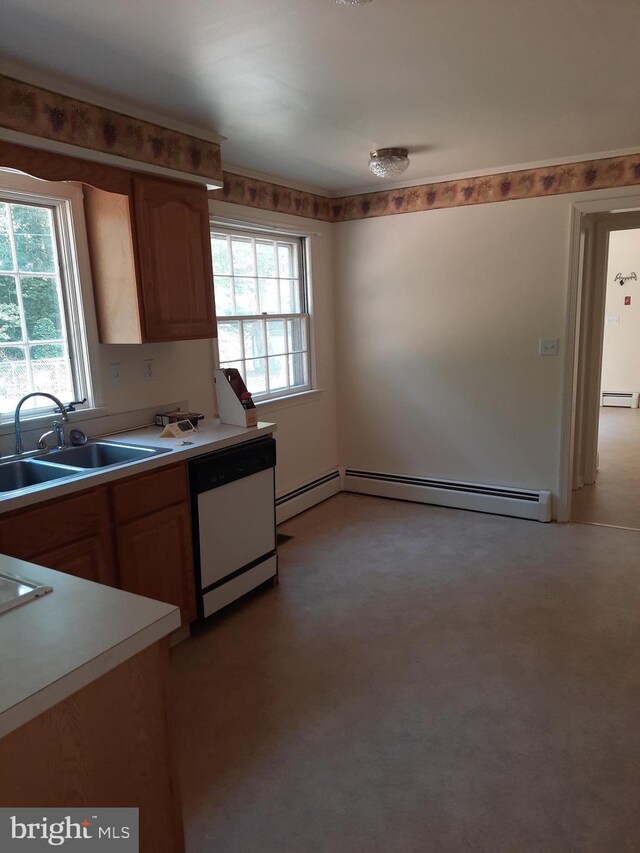 kitchen with a wealth of natural light, sink, white dishwasher, and a baseboard heating unit