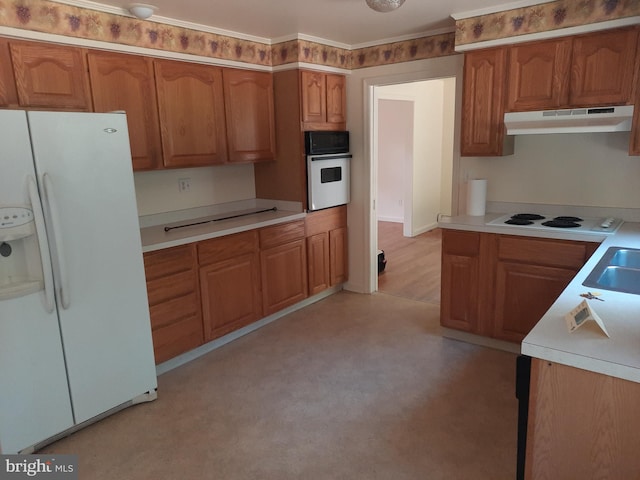 kitchen featuring white appliances and sink