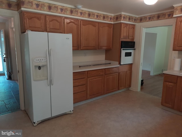 kitchen featuring crown molding and white appliances