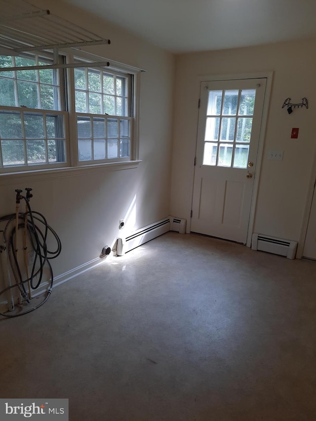 doorway featuring concrete flooring and a baseboard radiator