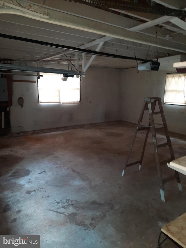 basement featuring electric panel and a wealth of natural light