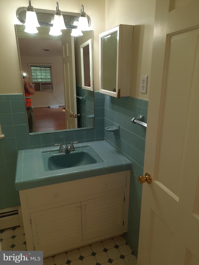 bathroom featuring vanity and baseboard heating