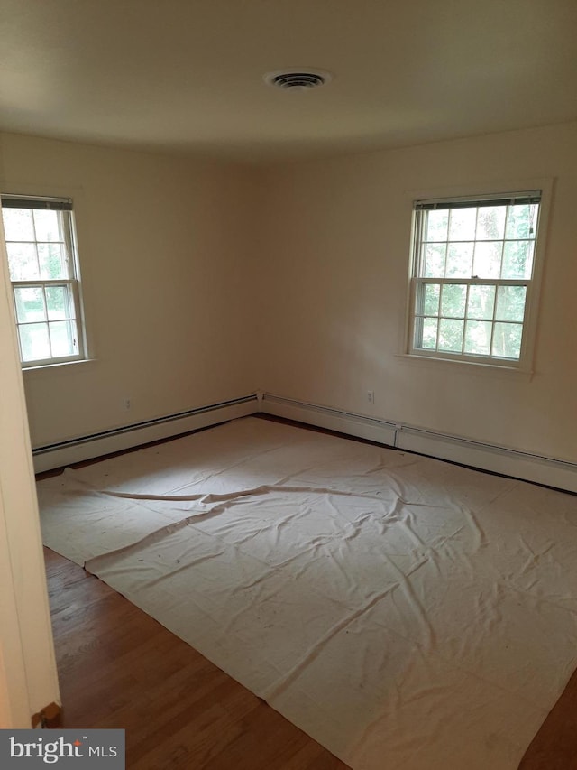 spare room with light hardwood / wood-style flooring