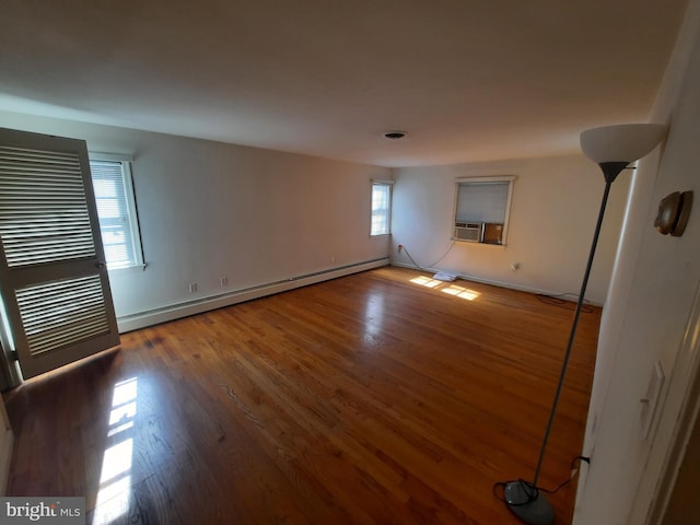 unfurnished room featuring hardwood / wood-style floors, cooling unit, and a baseboard radiator