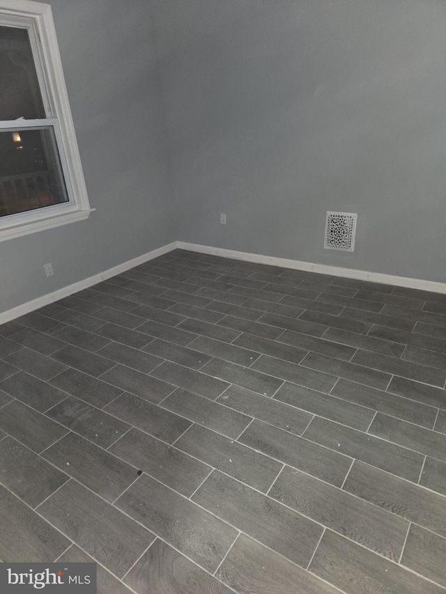 spare room with dark hardwood / wood-style flooring