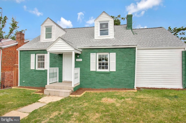 new england style home featuring a front yard