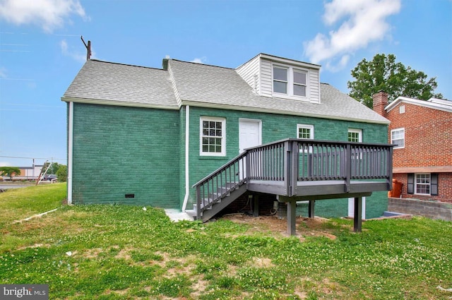 back of house with a yard and a deck