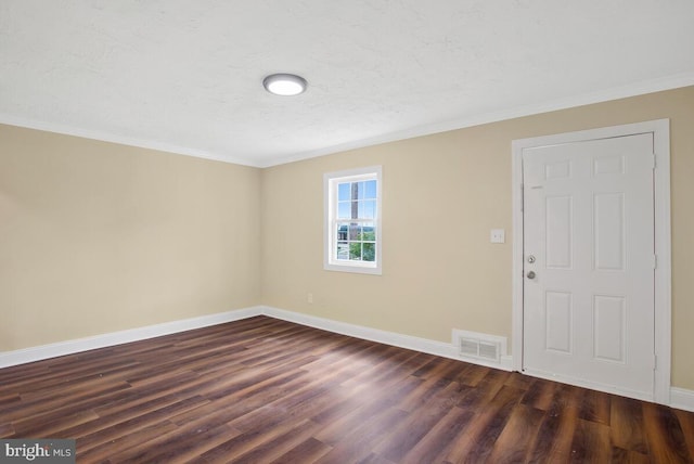 entryway featuring dark hardwood / wood-style floors, ornamental molding, and a textured ceiling