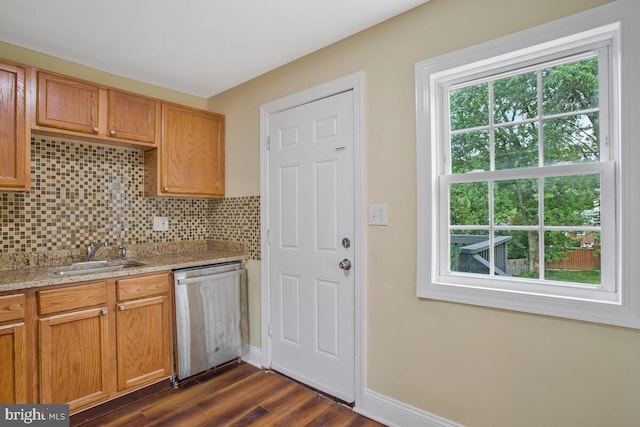 kitchen with dark hardwood / wood-style flooring, a wealth of natural light, sink, and stainless steel dishwasher