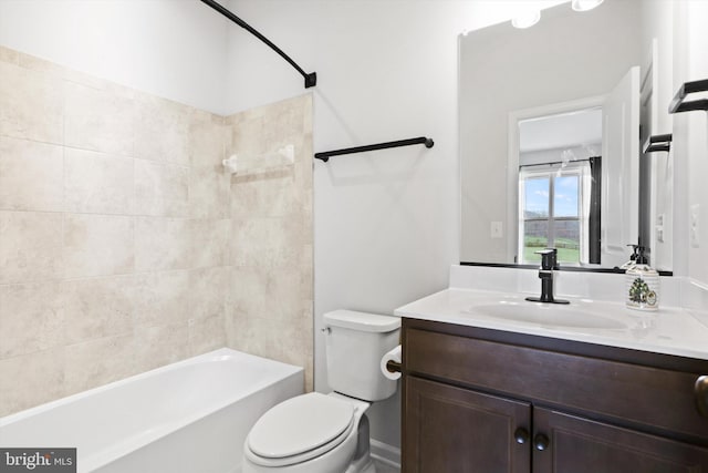 full bathroom featuring vanity, toilet, and tiled shower / bath