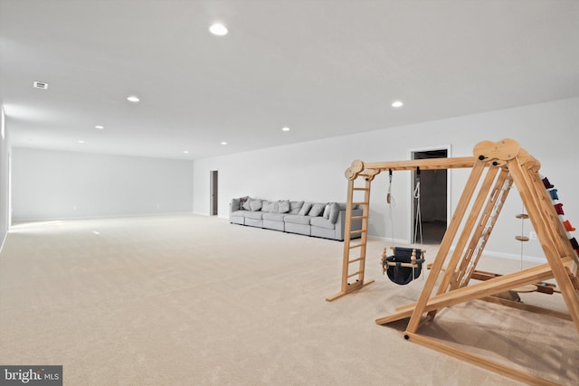 exercise room featuring light colored carpet