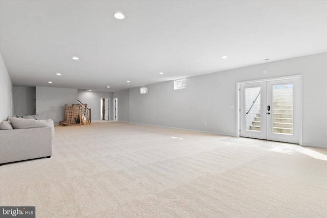 unfurnished living room with french doors and light colored carpet