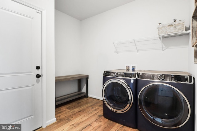 laundry room featuring washer and dryer and hardwood / wood-style flooring