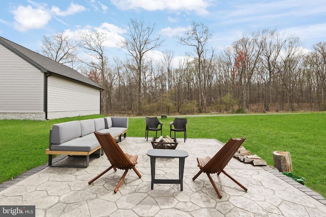 view of patio with an outdoor living space with a fire pit