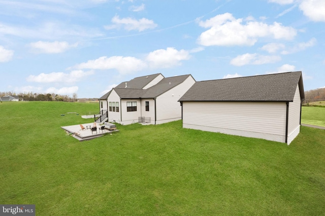 rear view of house featuring a patio area and a lawn