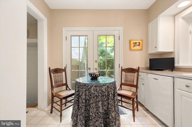 dining area with french doors and light tile patterned flooring