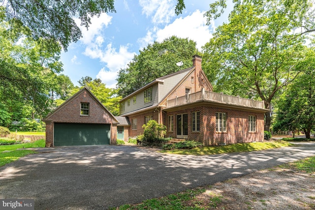 view of front facade featuring an outdoor structure and a garage