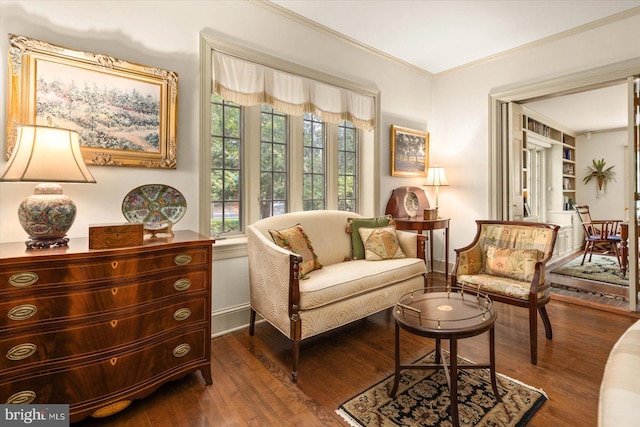 living area featuring ornamental molding and dark hardwood / wood-style flooring