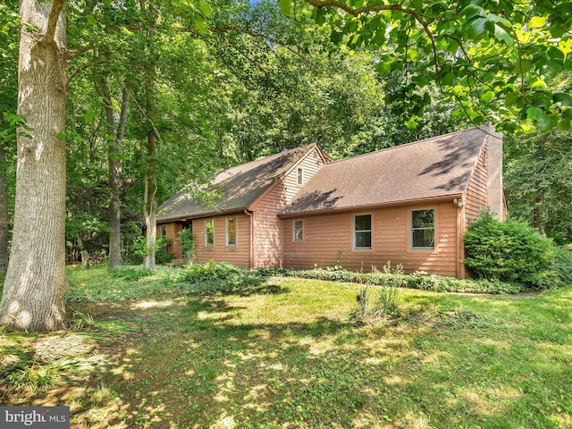 view of property exterior featuring a lawn