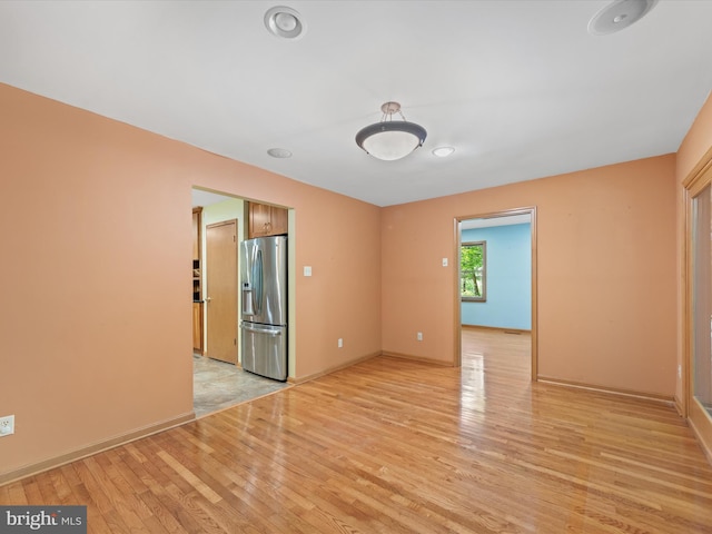 spare room with light hardwood / wood-style flooring