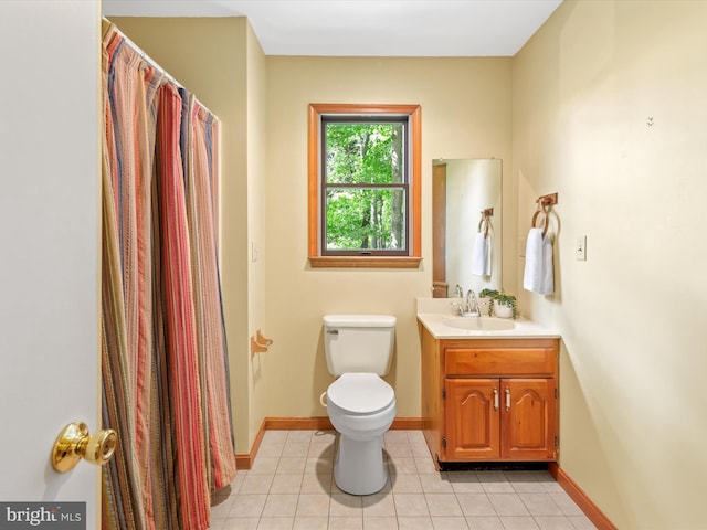 bathroom featuring tile patterned flooring, vanity, and toilet