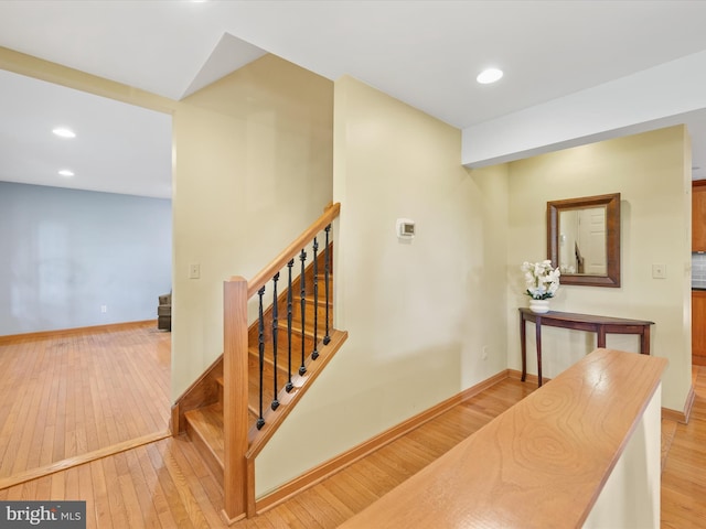 staircase with hardwood / wood-style flooring