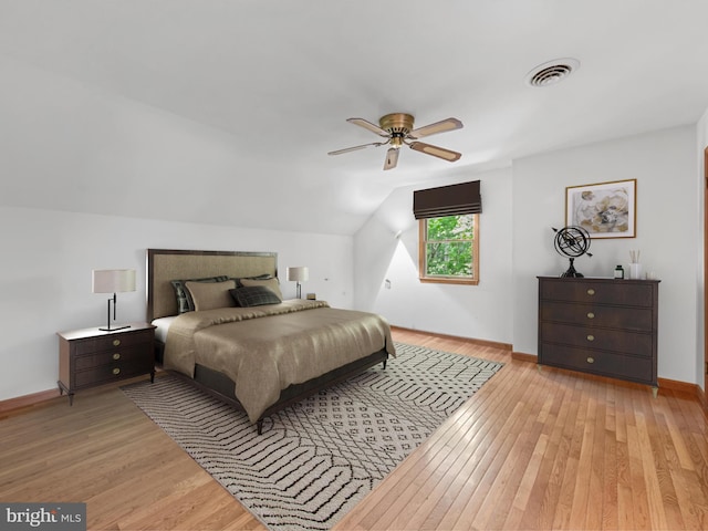 bedroom with vaulted ceiling, light hardwood / wood-style flooring, and ceiling fan