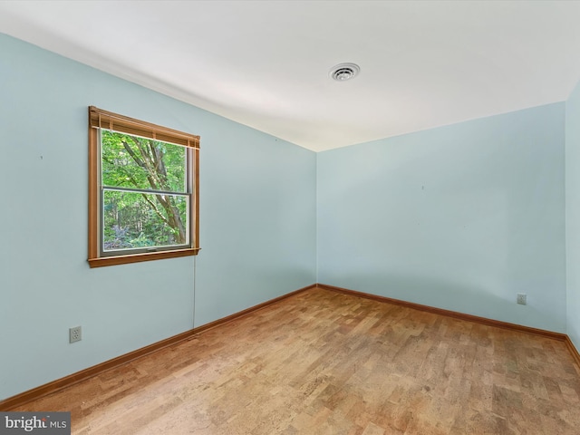 empty room with light hardwood / wood-style flooring