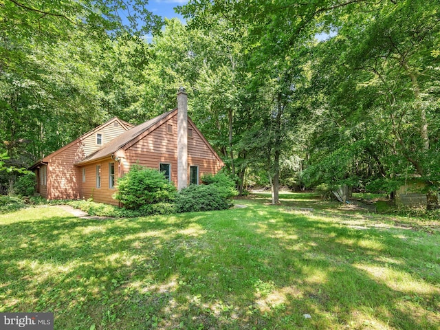 view of property exterior with a yard