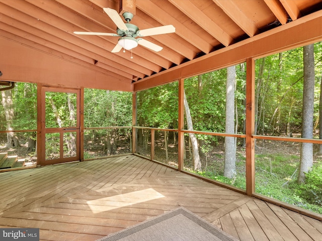 unfurnished sunroom featuring lofted ceiling with beams and ceiling fan