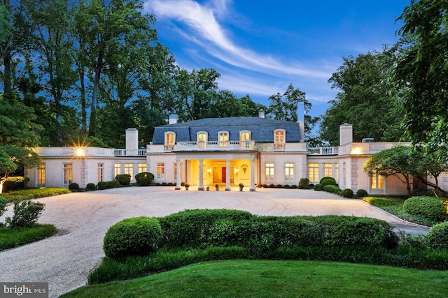 french provincial home featuring a front yard