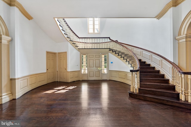 entrance foyer featuring hardwood / wood-style floors and a towering ceiling